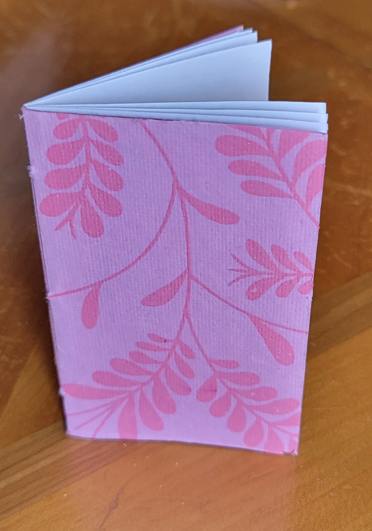 small pink folded pamphlet-style booklet